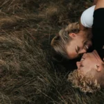 Two women are lying on the floor, embracing, as a symbol of lesbian dating